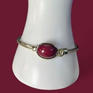 Bangle bracelet with a pretty maroon pink red gemstone